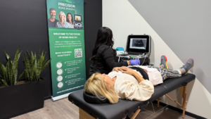 Technician performing REMS bone density scan on woman lying on treatment table — bone density scan results explained and what your T-score really means.